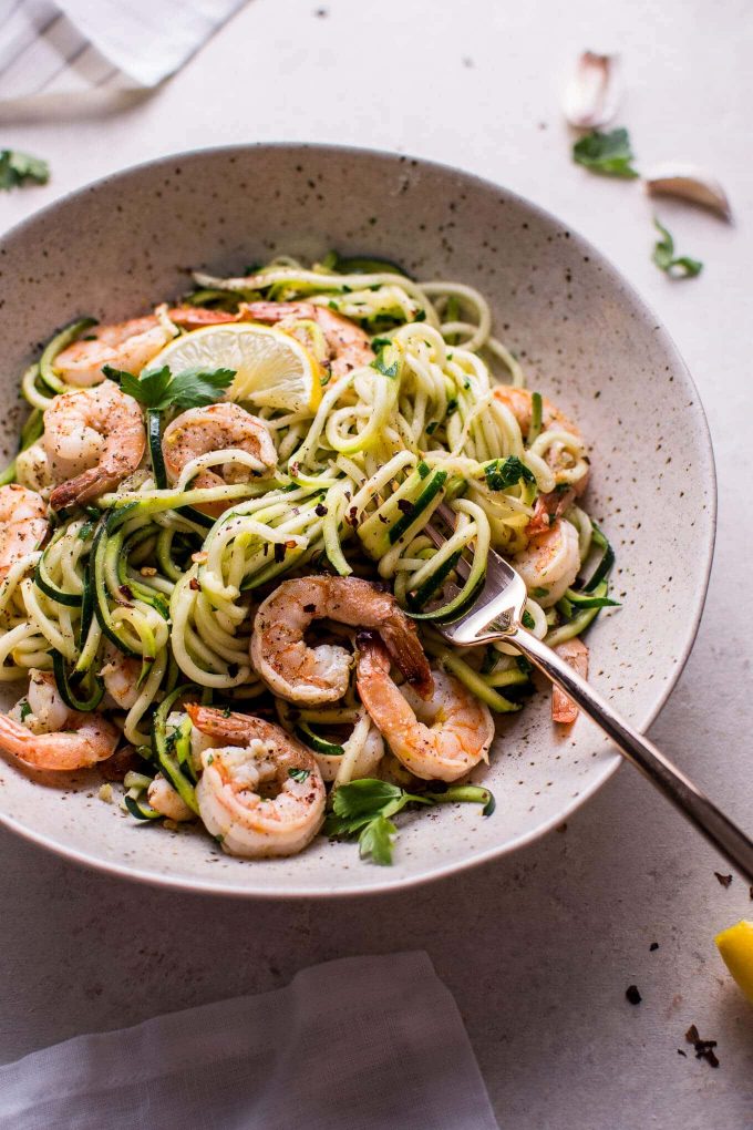 close-up of garlic shrimp zoodles with a fork