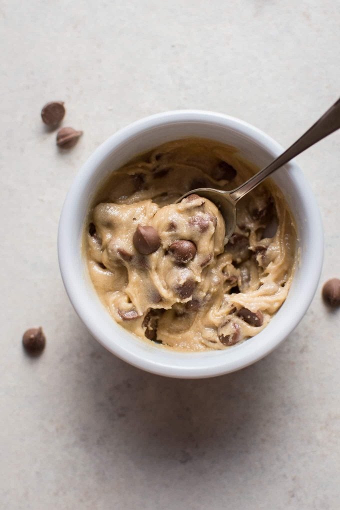 small white bowl of eggless chocolate chip cookie dough for one with a spoon