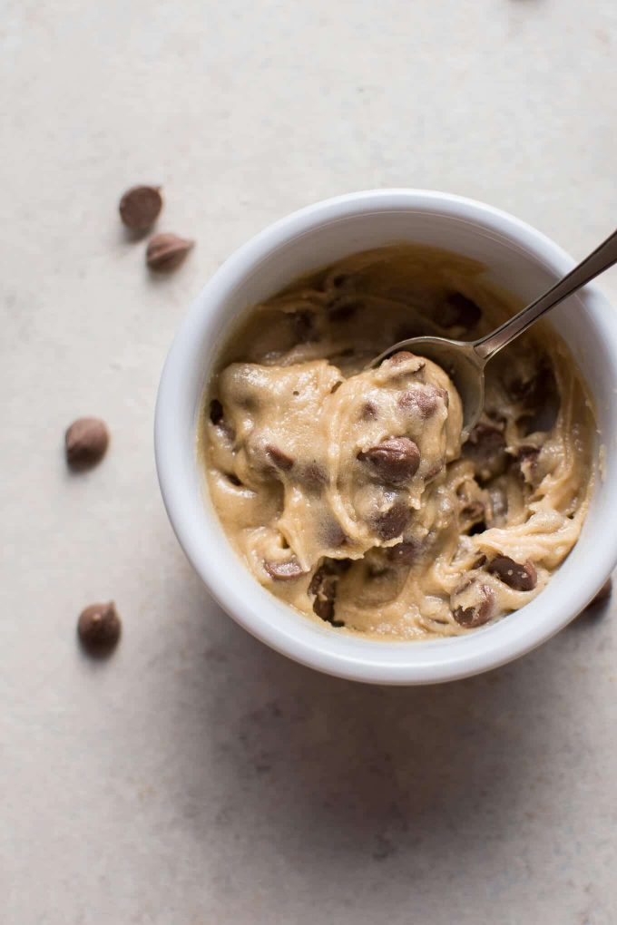 close-up of small bowl of guilt-free eggless chocolate chip cookie dough for one with a spoon