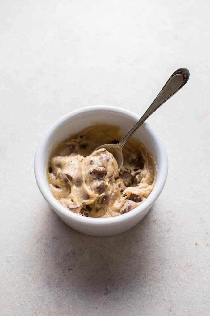 white bowl with guiltless egg-free cookie dough for one and a spoon