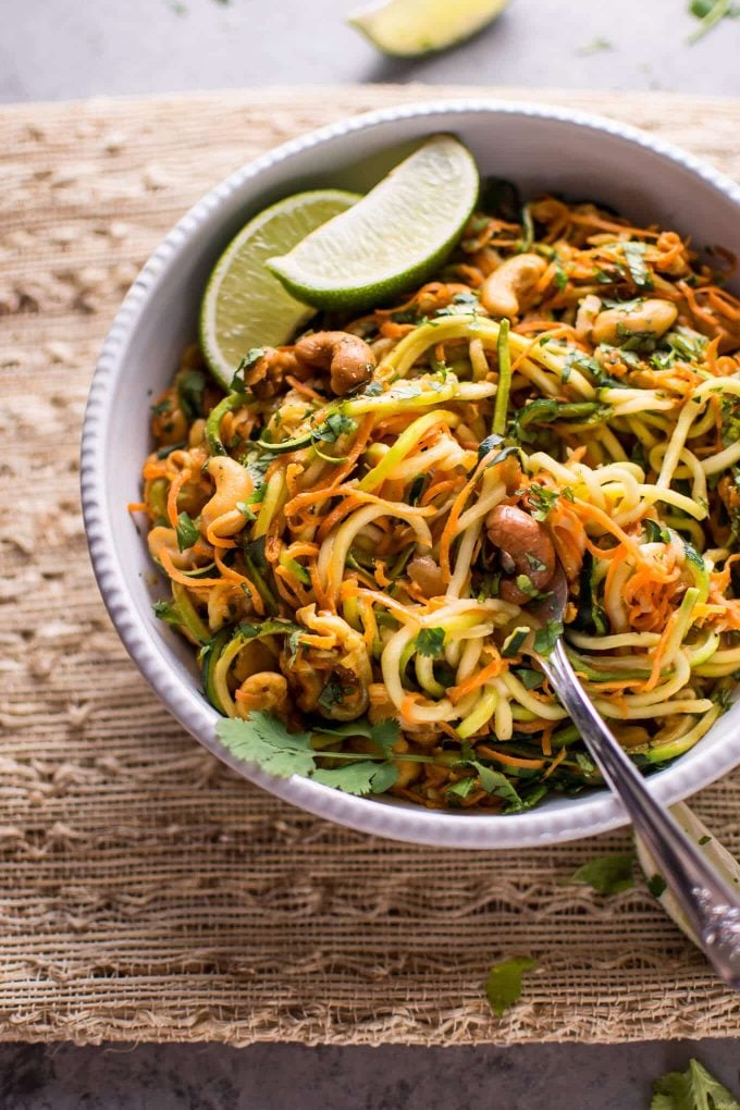 bowl of vegan garlic lime cashew zoodles with fork