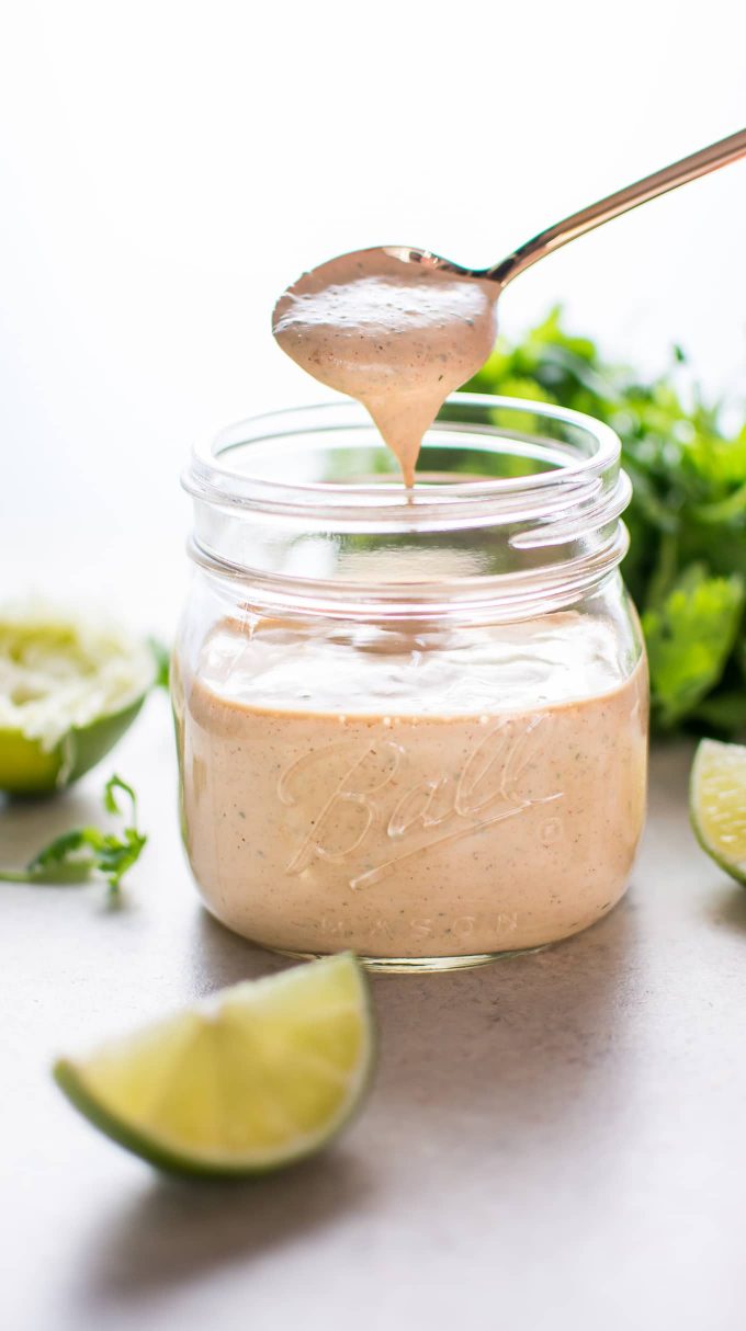 mason jar with Chipotle cilantro lime ranch dressing and spoon