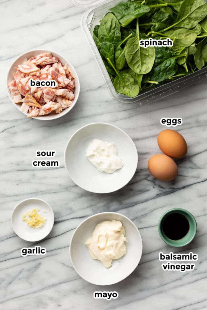 ingredients for spinach salad in prep bowls