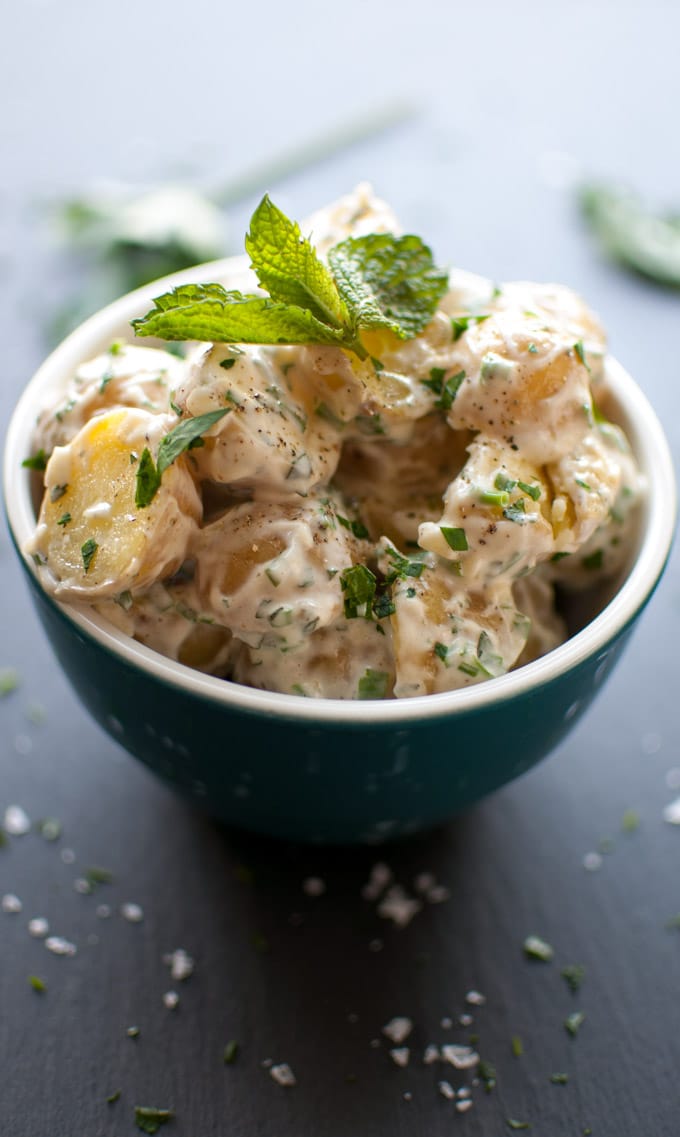 close-up of creamy baby potato salad in a bowl with mint garnish