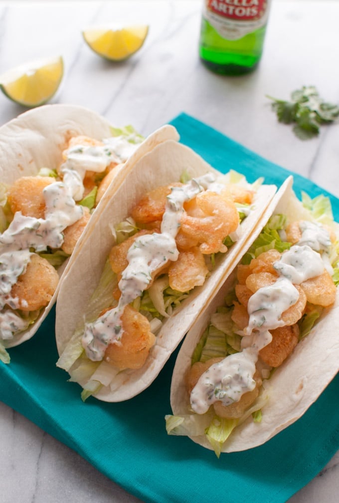 several beer battered shrimp tacos with cilantro lime cream