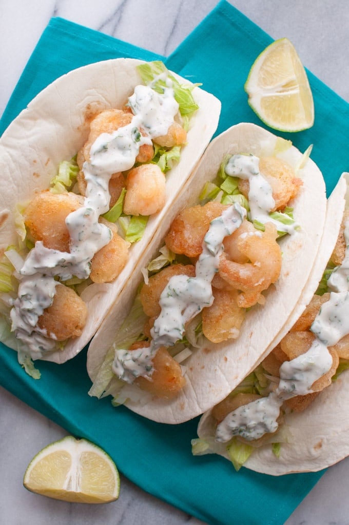 close-up of beer batter shrimp tacos with cilantro lime cream