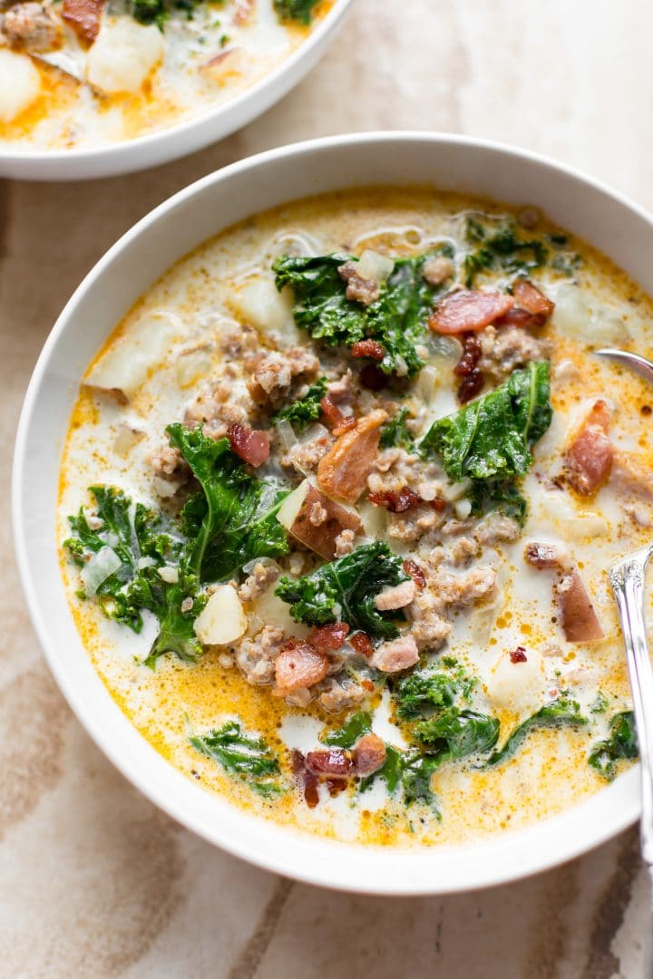 Electric pressure cooker Zuppa Toscana in a bowl with a spoon