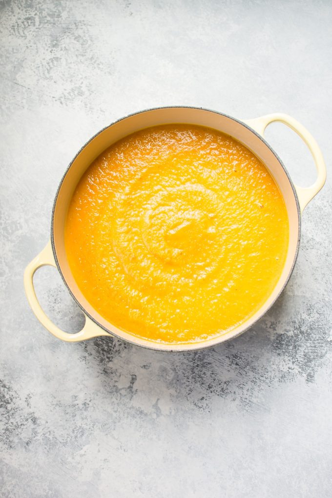 pot filled with acorn squash carrot soup