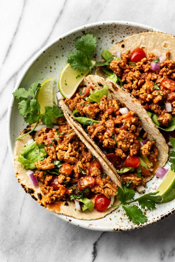 the best ground turkey tacos (3 tacos in a shallow bowl loaded with toppings)