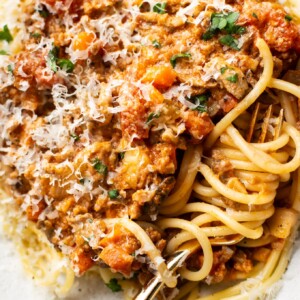 close-up of a shallow bowl with homemade spaghetti sauce over top of spaghetti