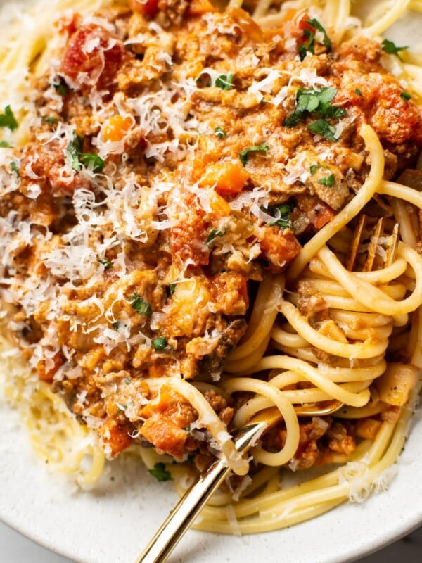 close-up of a shallow bowl with homemade spaghetti sauce over top of spaghetti