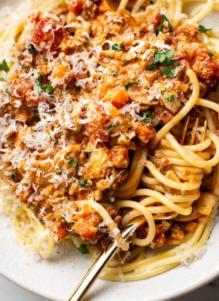 close-up of a shallow bowl with homemade spaghetti sauce over top of spaghetti