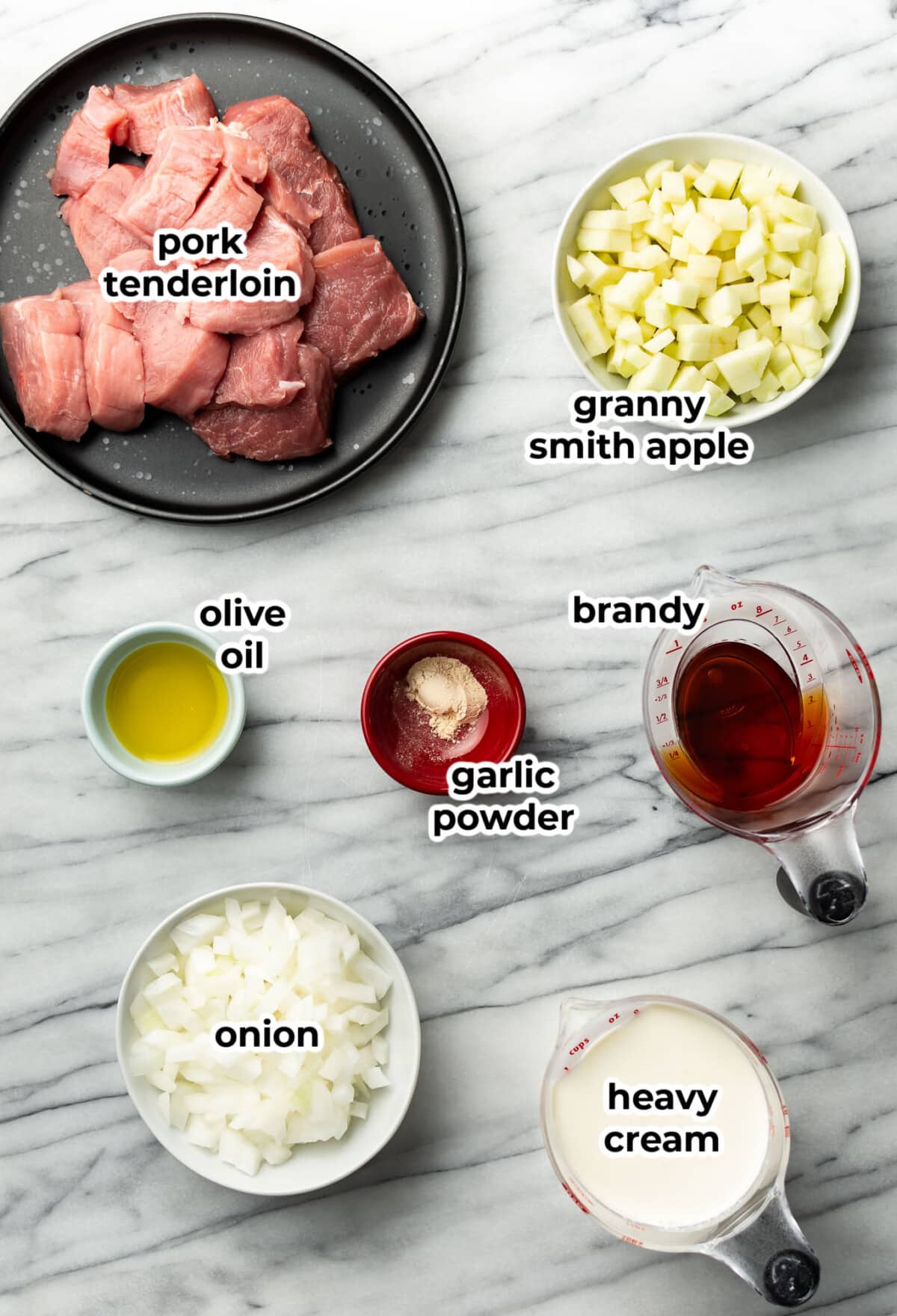 ingredients for pork tenderloin with brandy apple cream sauce in prep bowls