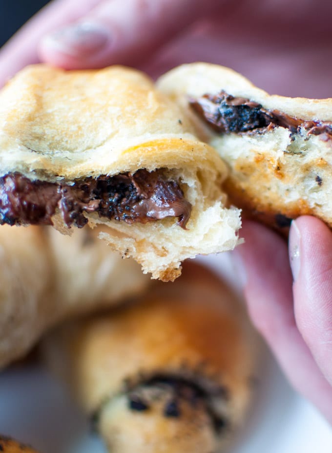 close-up of a hand holding a Nutella and Oreo stuffed crescent roll