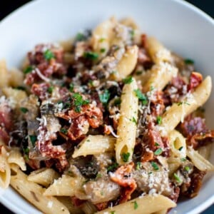 A delicious pasta dish with chorizo, portobello mushrooms, sun-dried tomatoes, and plenty of garlic!