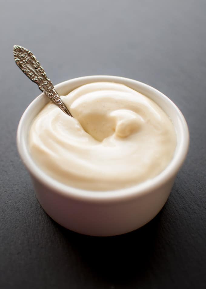 small white bowl with easy homemade mayo and a spoon