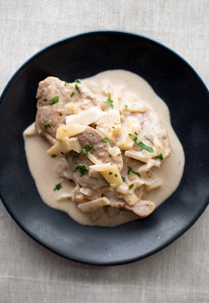 close-up of plate with pork tenderloin in brandy and apple cream sauce