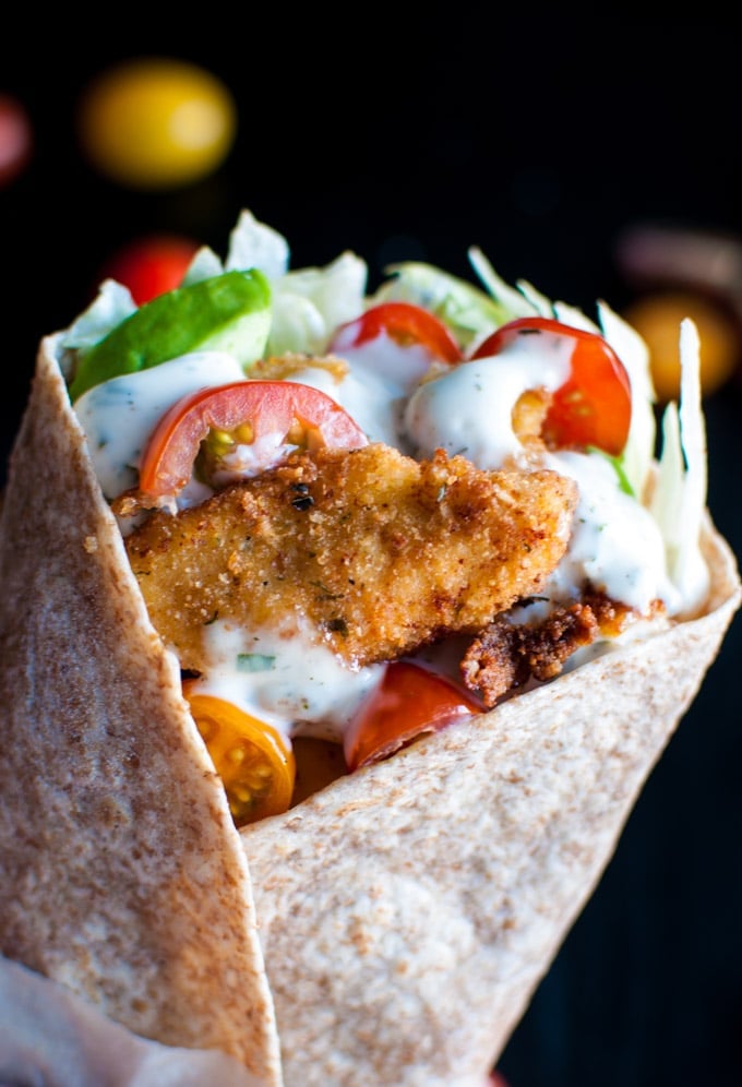 close-up of a fried chicken wrap with plenty of homemade ranch dressing