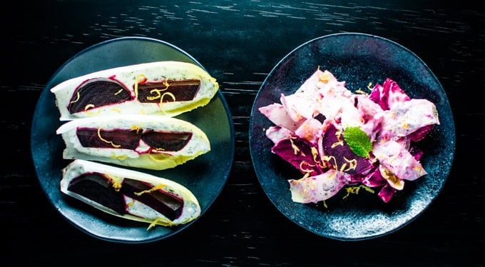 two black bowls with beet, endive, fresh herb, and Greek yogurt salad