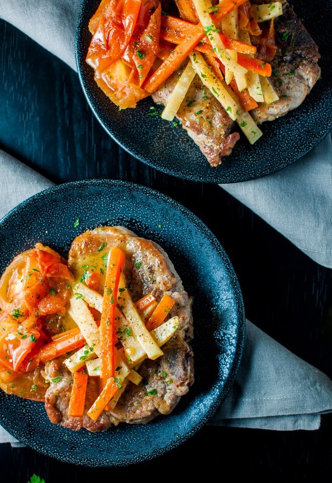 Pork chops in a delicious white wine, carrot, fresh tomato, and celeriac sauce - an elegant dish - Salt & Lavender