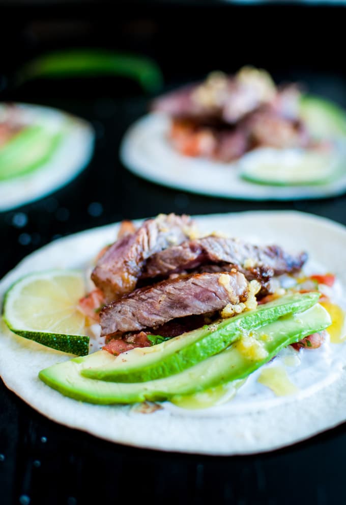 close-up of garlic butter steak taco with homemade pico de gallo and avocado topping