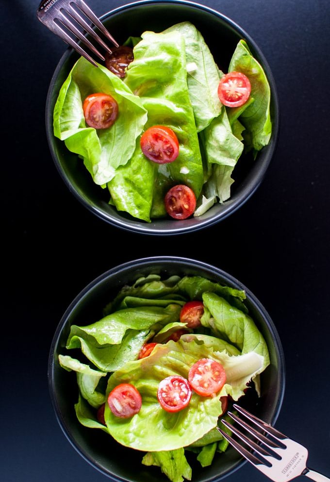 A whisk, garlic, rice vinegar, dijon mustard, shallots, and olive oil create a wonderful emulsion that will make your salad greens taste fantastic.