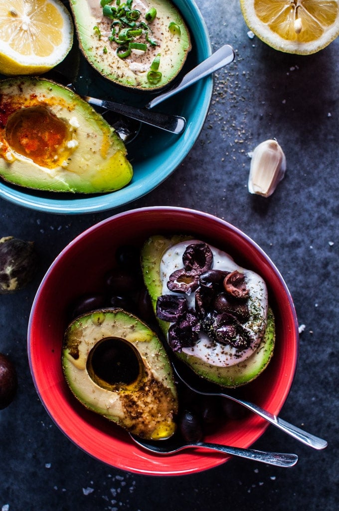 two bowls of four avocado halves four ways with spoons