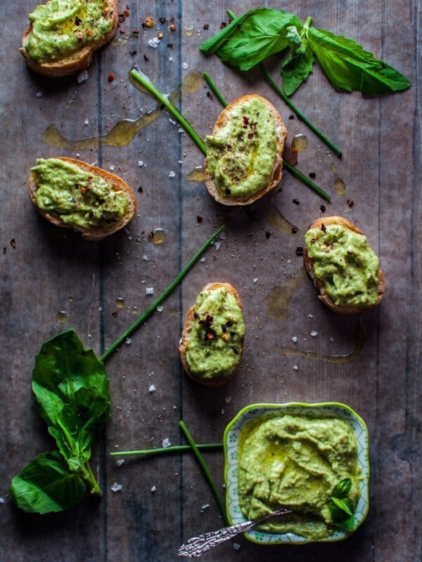 Avocado pesto is a versatile condiment that is great on bread or crackers or with pasta. Avocado, chives, basil, garlic, olive oil, lime, and pine nuts come together to create this tasty spread.