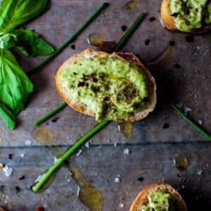 Avocado pesto is a versatile condiment that is great on bread or crackers or with pasta. Avocado, chives, basil, garlic, olive oil, lime, and pine nuts come together to create this tasty spread.