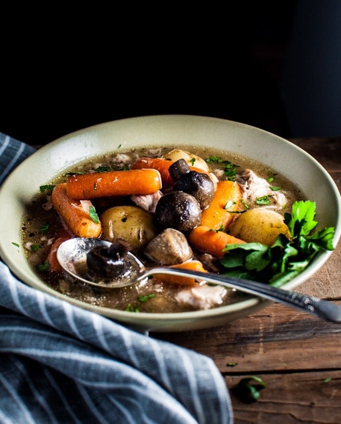 bowl of hearty slow cooker chicken stew in a bowl with a spoon