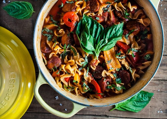 yellow pot with close-up of chorizo, pepper, and tomato noodles