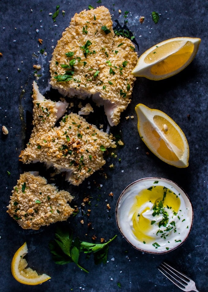 panko crusted honey dijon basa fish with small bowl of garlic yogurt and lemon wedges