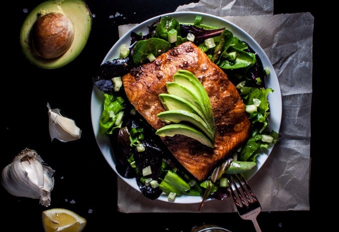 plate with healthy salmon salad with toasted sesame dressing and a fork