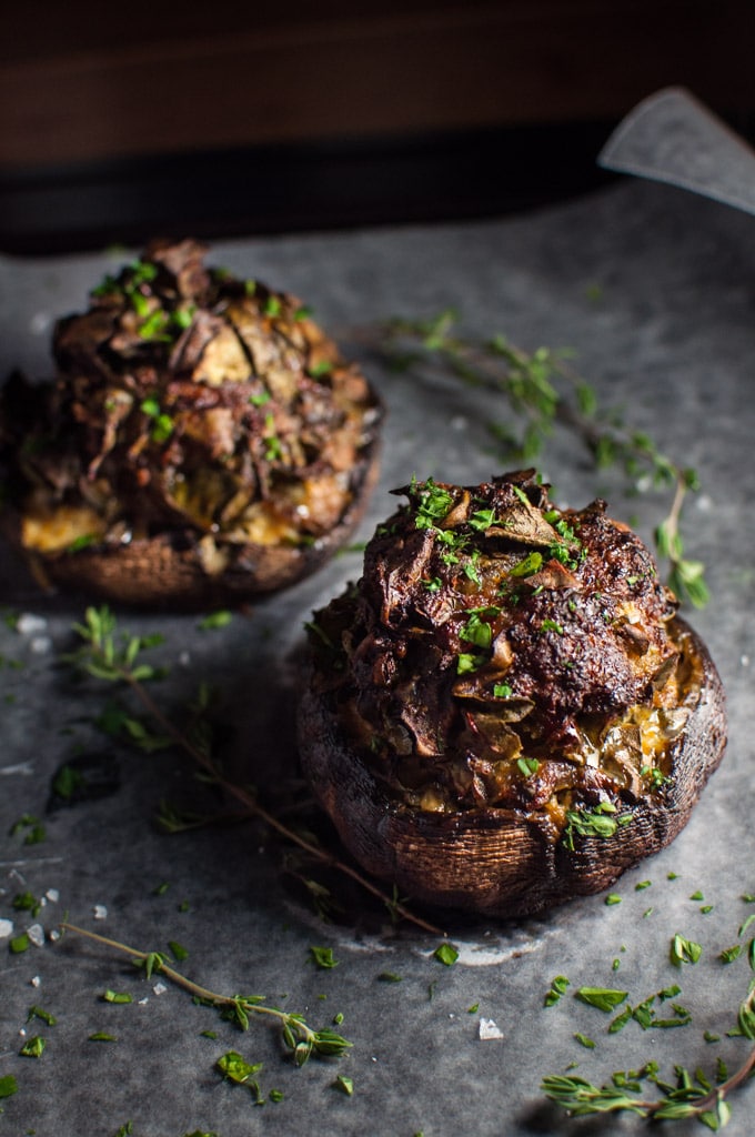 two portobello mushrooms stuffed with sausage, parmesan, Swiss chard, and garlic