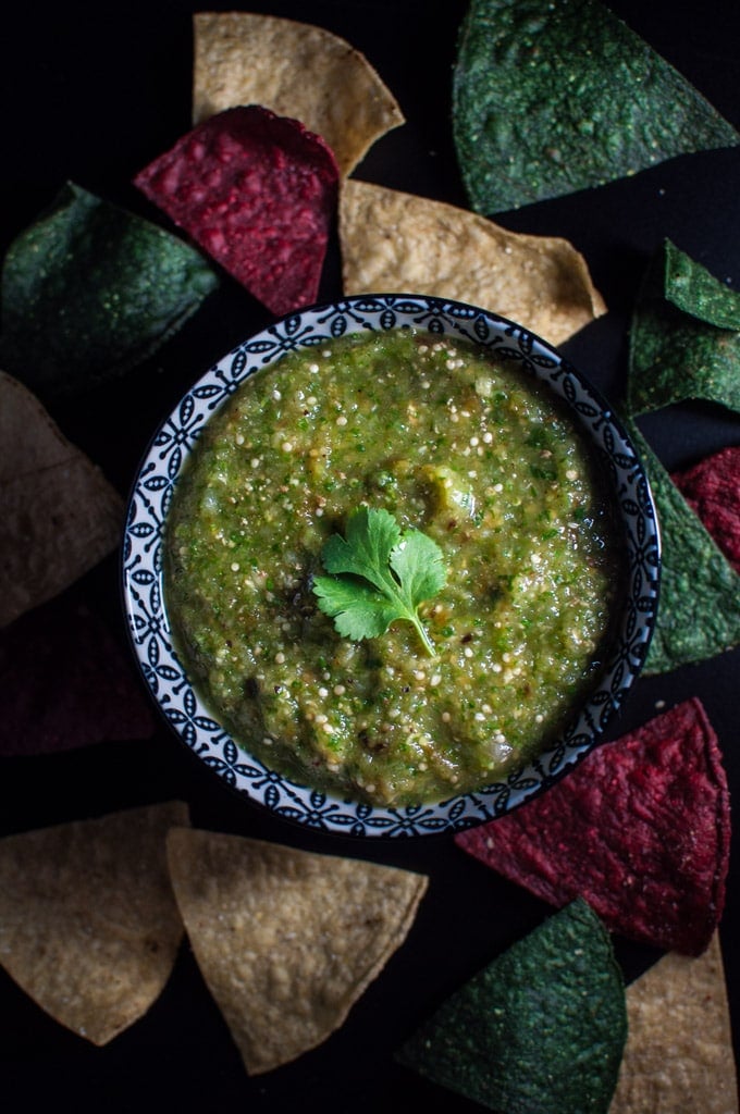 bowl of roasted tomatillo salsa verde beside several tortilla chips