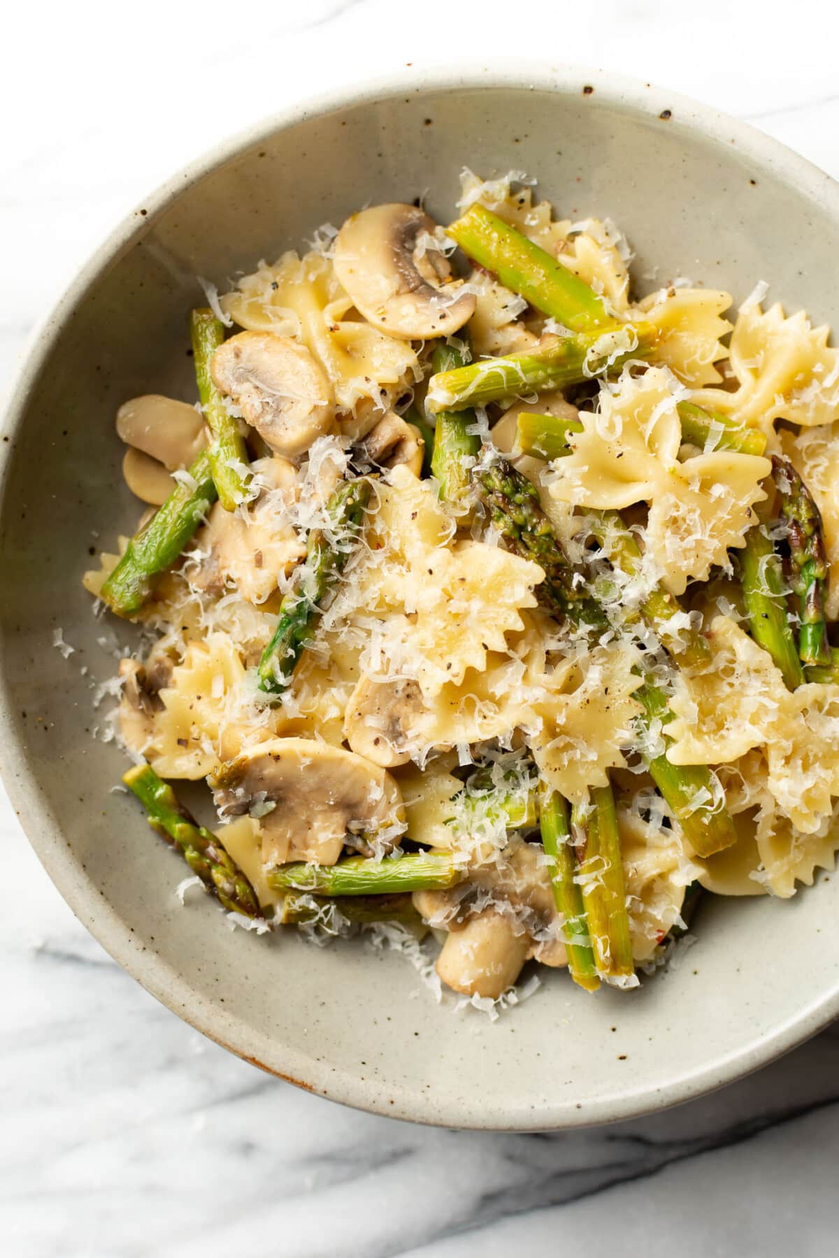 a bowl of mushroom and asparagus pasta