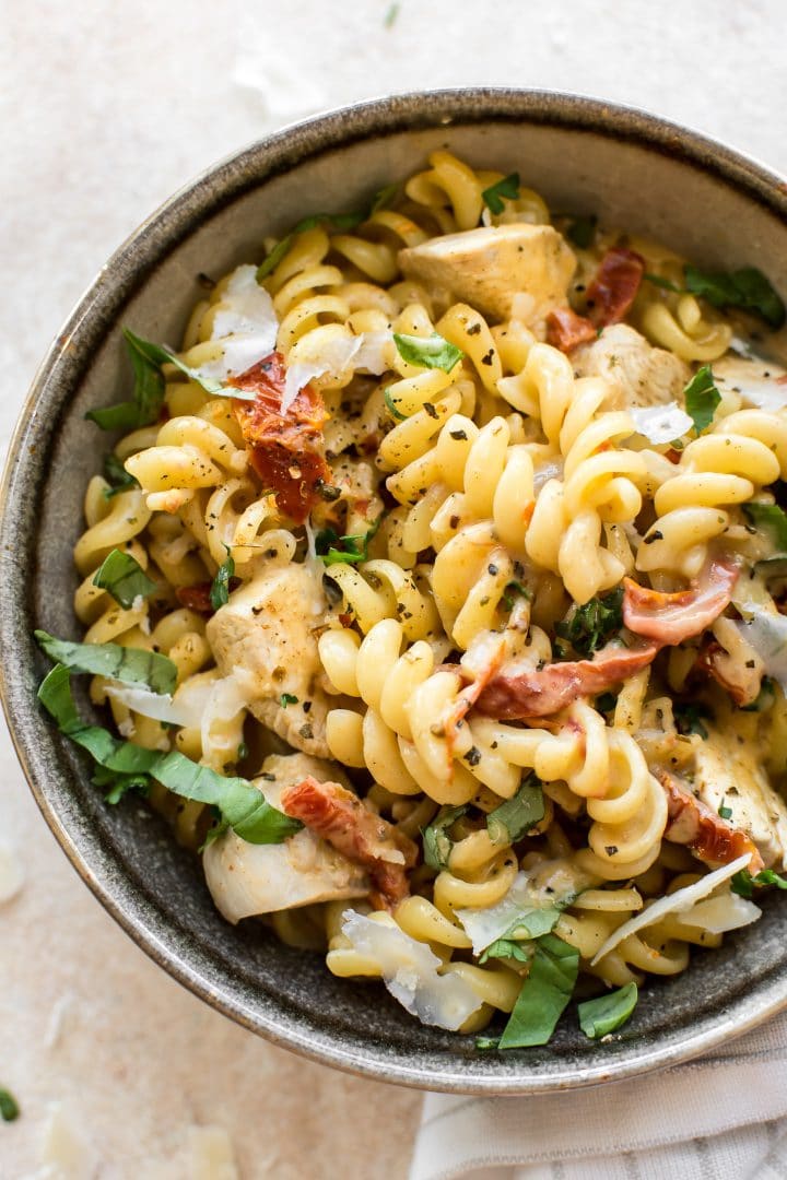 a stoneware bowl with creamy Cajun chicken pasta