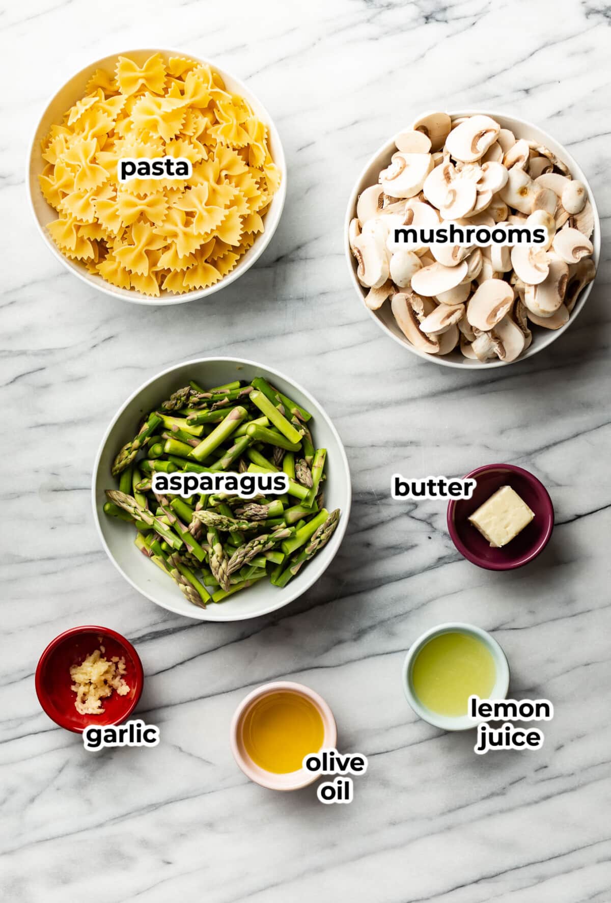 ingredients for asparagus and mushroom pasta in prep bowls