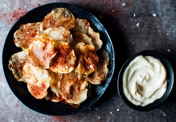 bowl of small batch microwave chips with sea salt, paprika, and olive oil with small bowl of truffle mayo dip