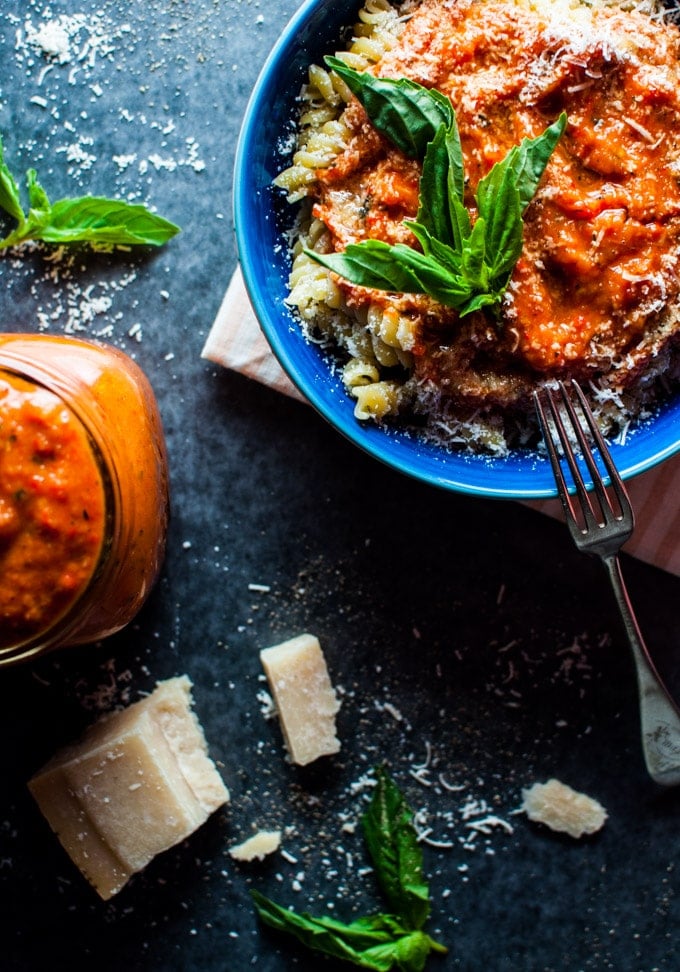 easy roasted tomato and red pepper sauce on pasta in a blue bowl with a fork