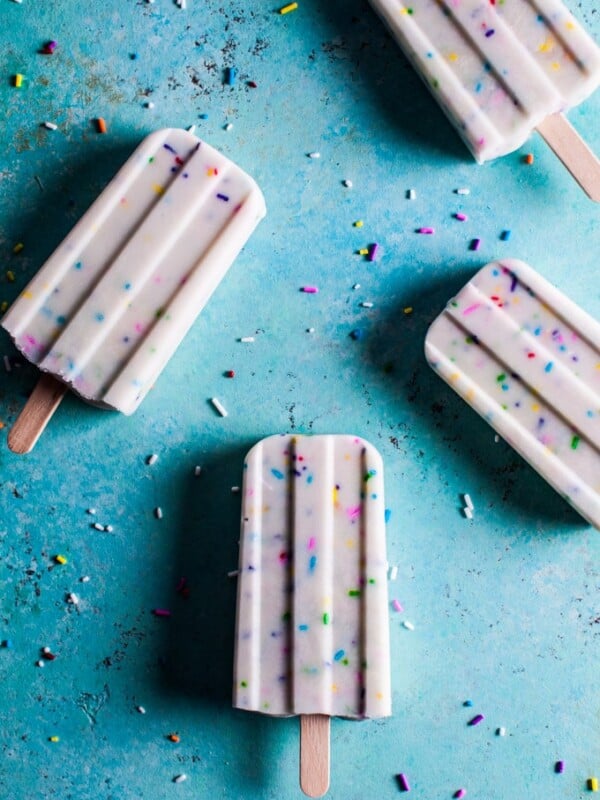 These vanilla Greek yogurt funfetti popsicles are super cute and easy to make - only 4 ingredients are needed! Kids and adults alike will love them!