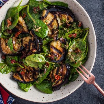 This grilled eggplant and spinach salad makes a wonderfully fresh, healthy, and filling warm weather meal. The eggplant is smoky and delicious, and the smoked paprika in the lemony dressing enhances its flavor even more.