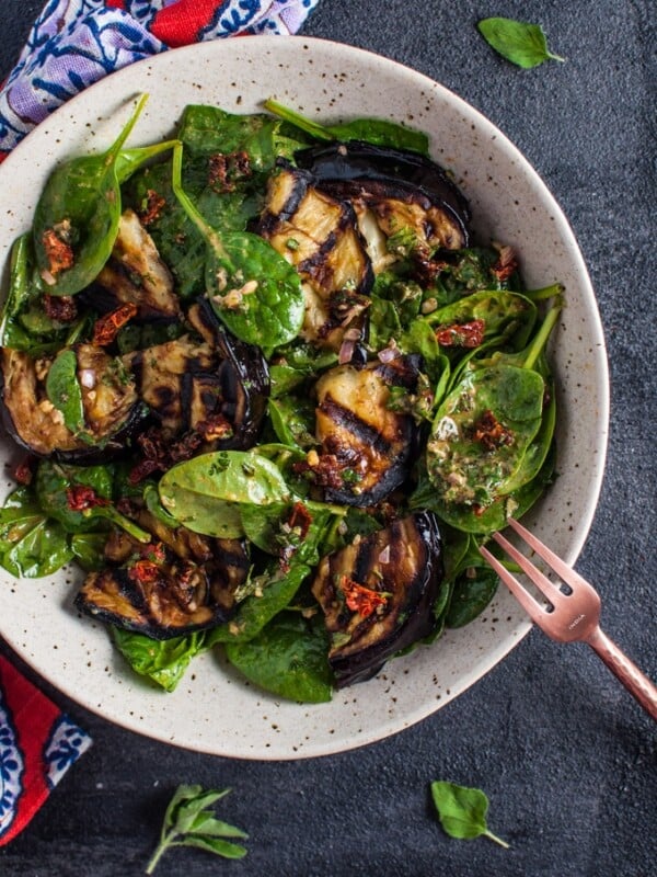 This grilled eggplant and spinach salad makes a wonderfully fresh, healthy, and filling warm weather meal. The eggplant is smoky and delicious, and the smoked paprika in the lemony dressing enhances its flavor even more.