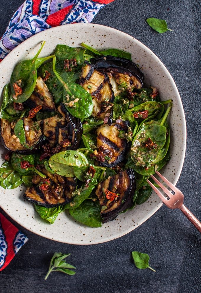 This grilled eggplant and spinach salad makes a wonderfully fresh, healthy, and filling warm weather meal. The eggplant is smoky and delicious, and the smoked paprika in the lemony dressing enhances its flavor even more.