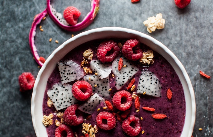 close-up of berry and dragon fruit toppings on healthy breakfast smoothie bowl