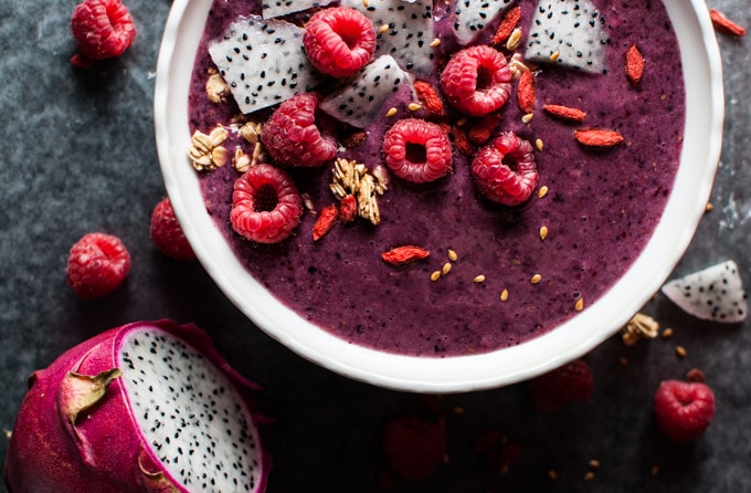 close-up of mixed berry smoothie bowl with dragon fruit and fresh raspberries