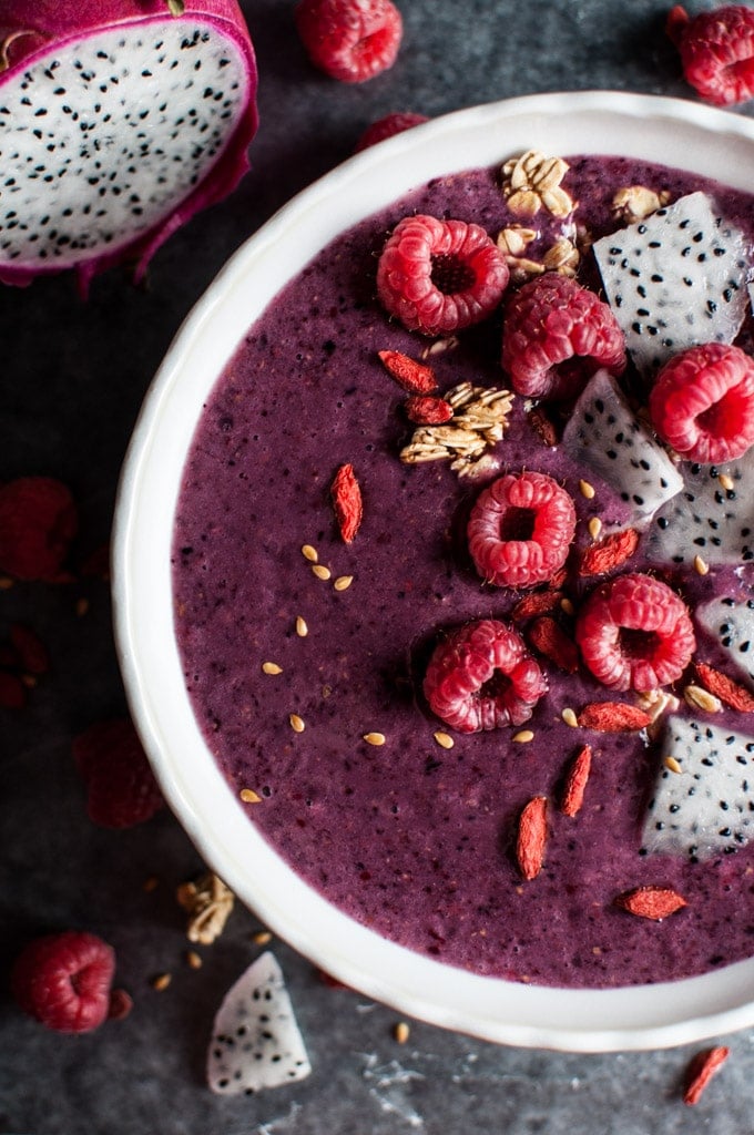 close-up of mixed berry and dragonfruit smoothie bowl with fresh raspberries