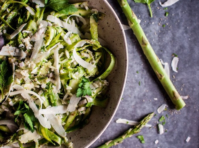 close-up of shaved asparagus salad with parmesan in a bowl