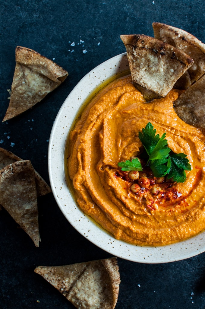 bowl with spicy sriracha and red pepper hummus and pita bread