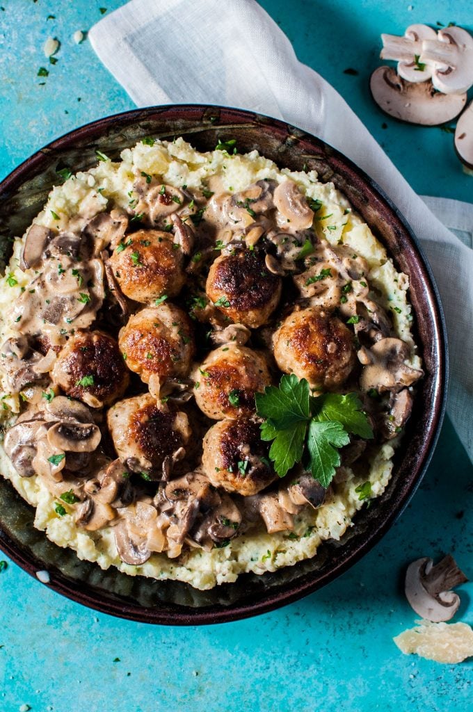 bowl with chicken meatballs in a creamy mushroom sauce served over mashed potatoes